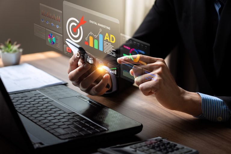 Marketer reviewing advertising performance dashboard and campaign budget on a laptop