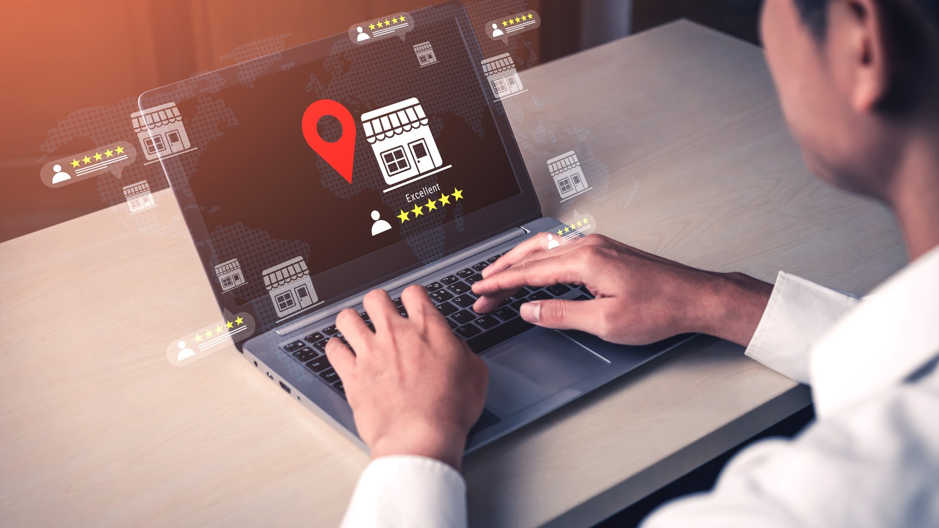 Small business owner reviewing customer reviews and location data on a laptop while deciding whether to send an AI-drafted reply.