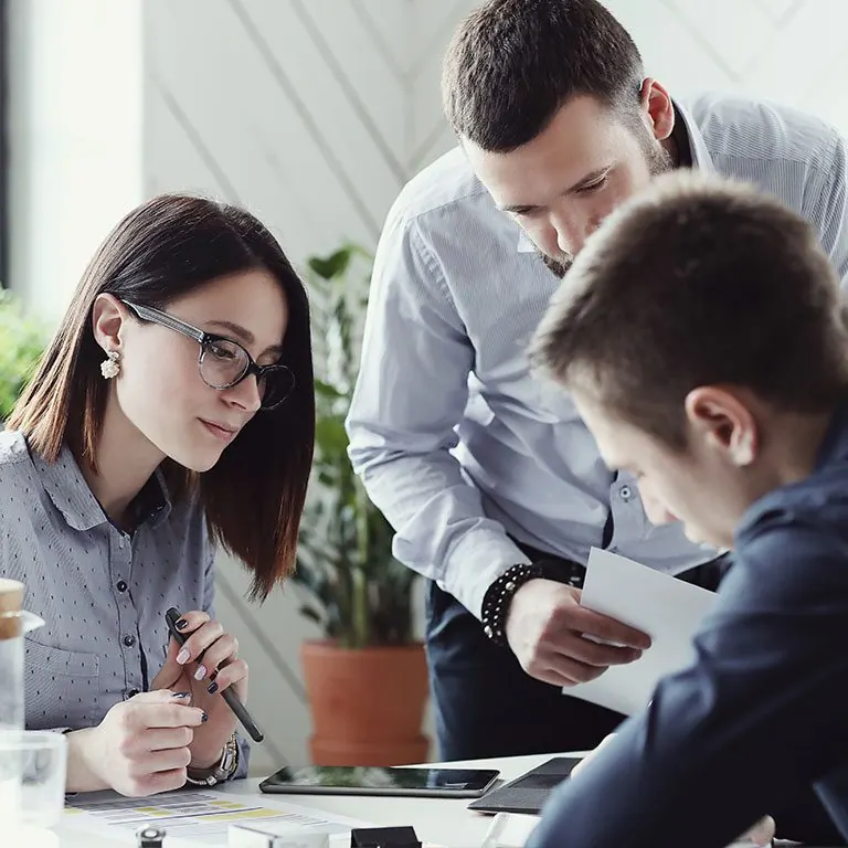 Marketing team reviewing campaign plans at a table