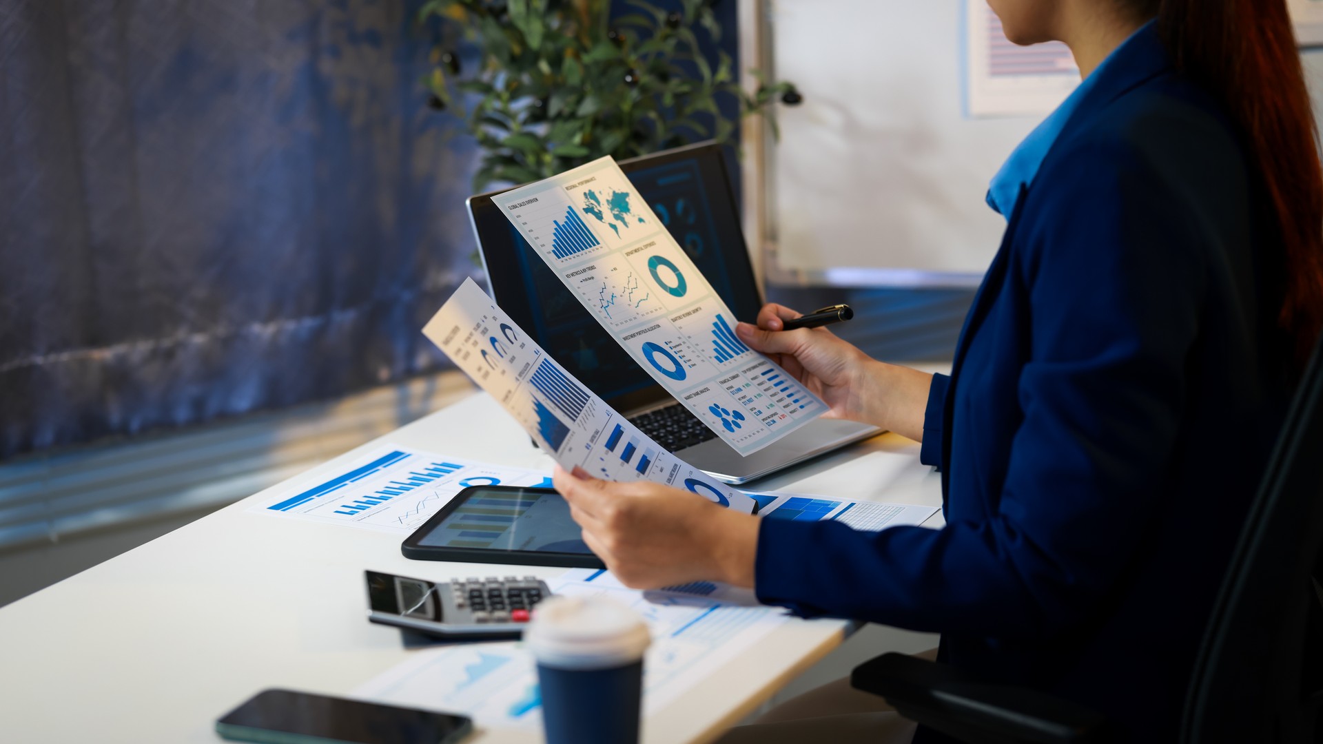 Small-business owner at a desk weighing a ChatGPT SEO service proposal on a laptop