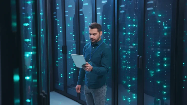 Data center technician monitoring server infrastructure on a tablet during a hosting outage